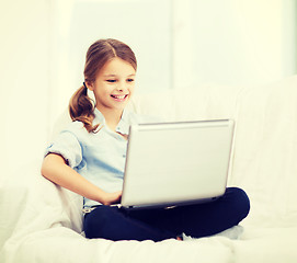 Image showing smiling girl with laptop computer at home