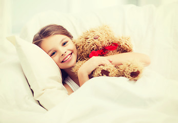 Image showing little girl with teddy bear sleeping at home