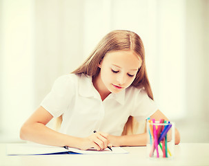 Image showing little student girl drawing at school