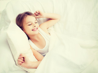 Image showing smiling girl child waking up in bed at home