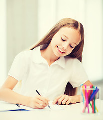 Image showing little student girl drawing at school