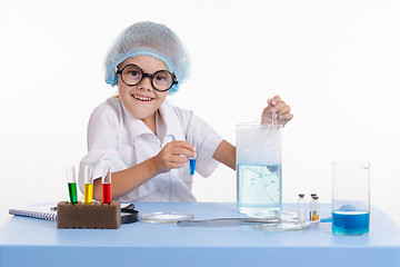 Image showing Cheerful girl chemist puts experience