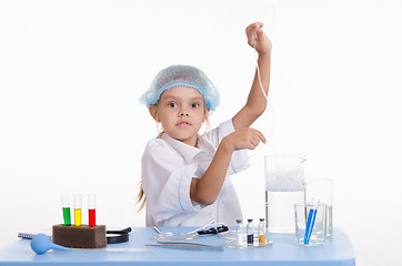 Image showing Chemist adjusts air hose to the flask