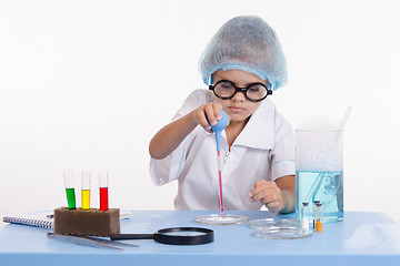 Image showing Young Chemist dripping jet on powder