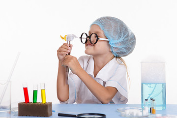 Image showing Girl holding in tweezers candy
