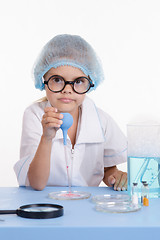 Image showing Young serious chemist with a pipette