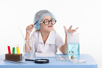 Image showing Chemist studying resulting foam in the flask