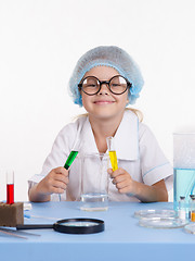 Image showing Young chemist mixes the liquid