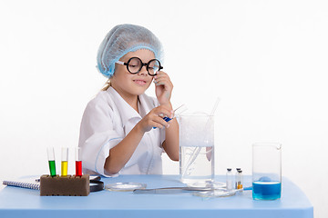 Image showing Girl pouring blue liquid in flask