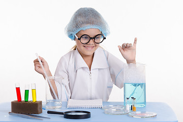 Image showing Girl chemist rejoices successful experience