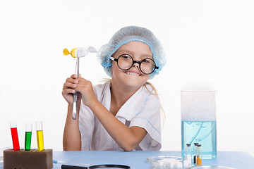 Image showing Girl holding a chemist tweezers candy