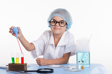 Image showing Young Chemist gaining pipetted liquid from a test tube