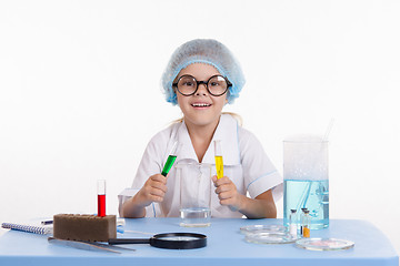 Image showing Young chemist mixes the two liquids