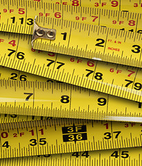 Image showing Close up of metal yellow measuring tapes 