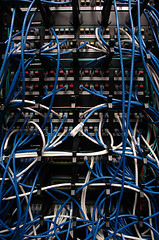 Image showing Banks of wires connecting network servers, telephones & digital 