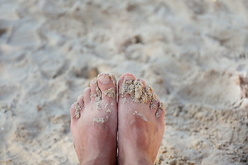 Image showing beach with feet of the man on sand