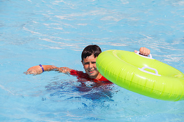 Image showing Boys swimsuit floating in the pool float 