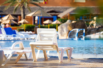 Image showing sunloungers on swimming pool 