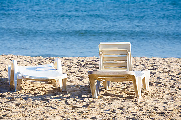 Image showing two old sunloungers on tunisian beach