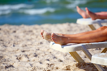 Image showing woman legs relaxing on the beach 