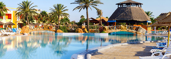 Image showing sunloungers on swimming pool