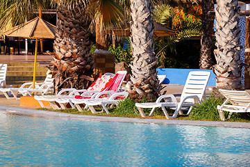 Image showing sunloungers on swimming pool 