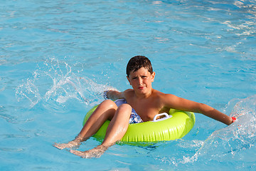 Image showing Boys swimsuit floating in the pool float 