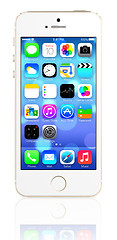 Image showing Gold iPhone 5s showing the home screen with iOS7.
