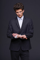 Image showing Business man looking on his wrist