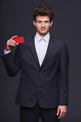 Image showing Smiling business man showing blank credit card