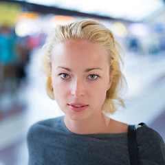 Image showing Young woman on platform of railway station.