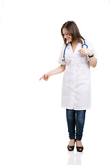 Image showing Beautiful young veterinary looking down and pointing, isolated o