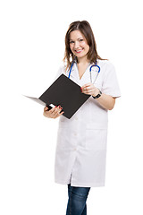 Image showing Beautiful young veterinary holding a folder, isolated over white