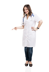 Image showing Beautiful young veterinary looking down and pointing, isolated o