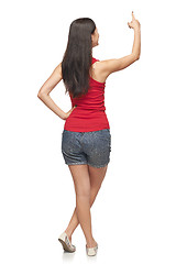 Image showing Female in full length pointing at blank copy space