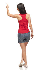 Image showing Female in full length pointing at blank copy space
