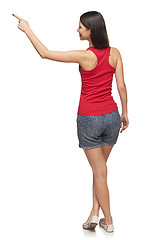 Image showing Female in full length pointing at blank copy space