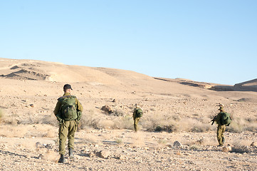 Image showing Soldiers patrol in desert