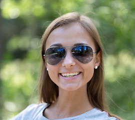 Image showing portrait of a girl in sunglasses in the forest