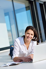 Image showing relaxed young woman at home working on laptop computer