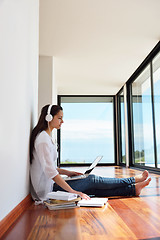 Image showing relaxed young woman at home working on laptop