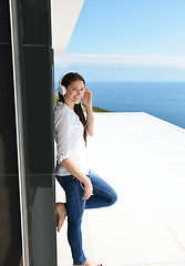 Image showing girl listening to the music on white headphones