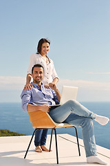 Image showing relaxed young couple working on laptop computer at home