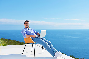 Image showing relaxed young man at home on balcony