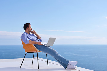 Image showing relaxed young man at home on balcony