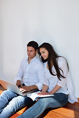 Image showing relaxed young couple working on laptop computer at home