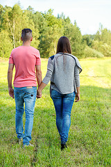 Image showing Rear view of young couple walking outdoor