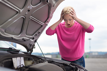 Image showing Stressed Young Woman with Car Defect.