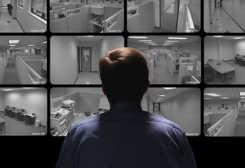 Image showing Security guard conducting surveillance by watching several secur