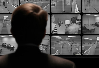 Image showing Man watching an employee work via a closed-circuit video monitor